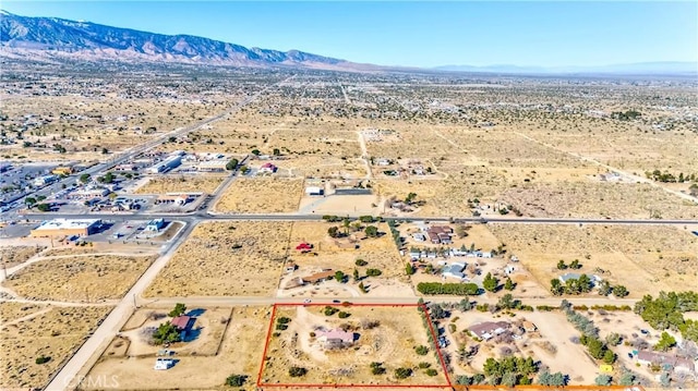 birds eye view of property featuring a rural view, a desert view, and a mountain view