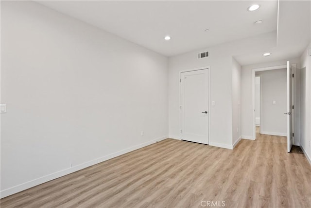 unfurnished bedroom featuring light wood finished floors, baseboards, and recessed lighting