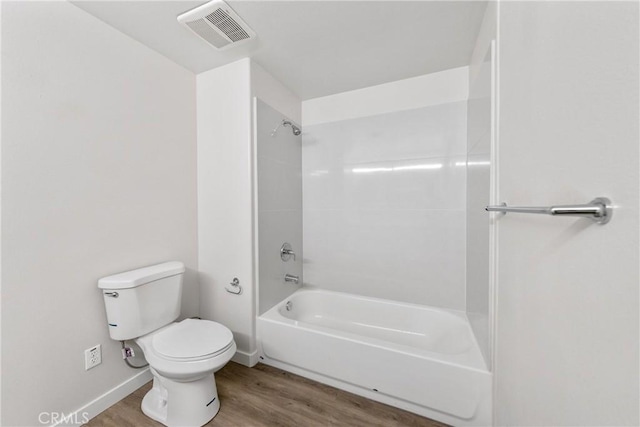 full bath featuring baseboards, visible vents, toilet, wood finished floors, and shower / bathing tub combination