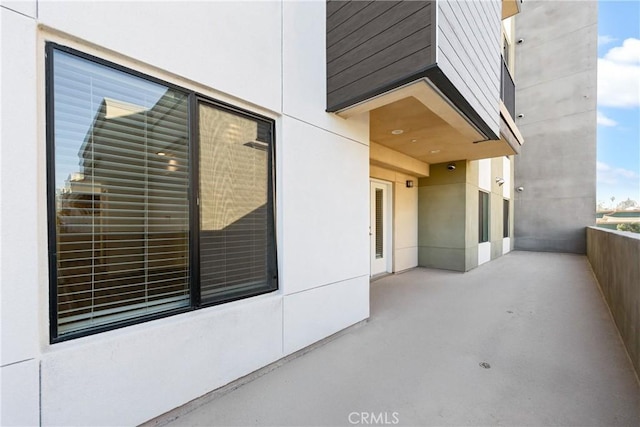 exterior space featuring a balcony and stucco siding