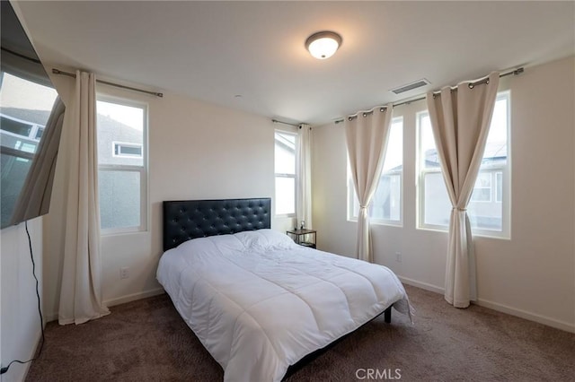 bedroom featuring baseboards, visible vents, and carpet flooring