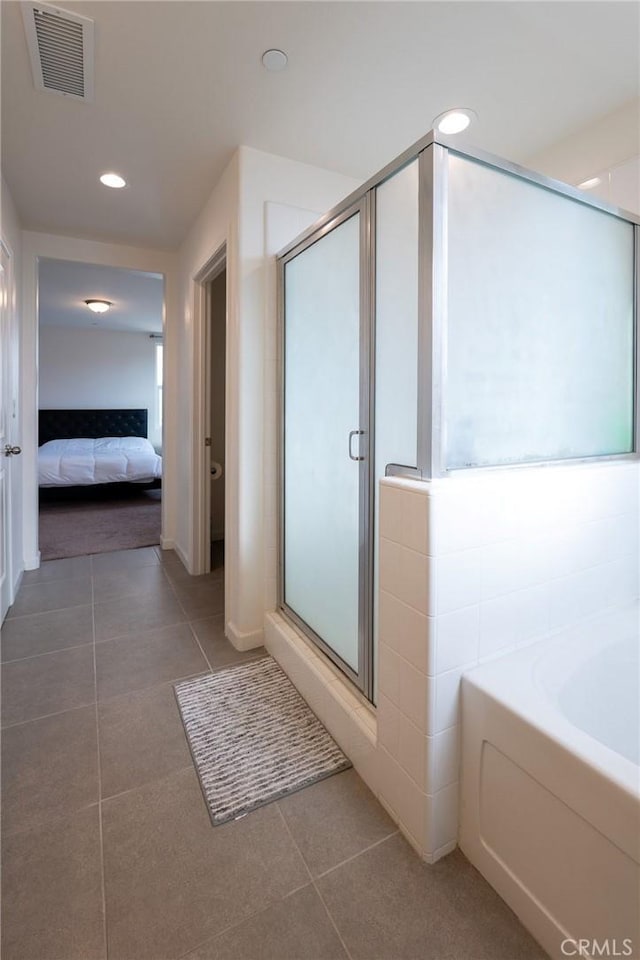 ensuite bathroom with a stall shower, ensuite bath, visible vents, and tile patterned floors