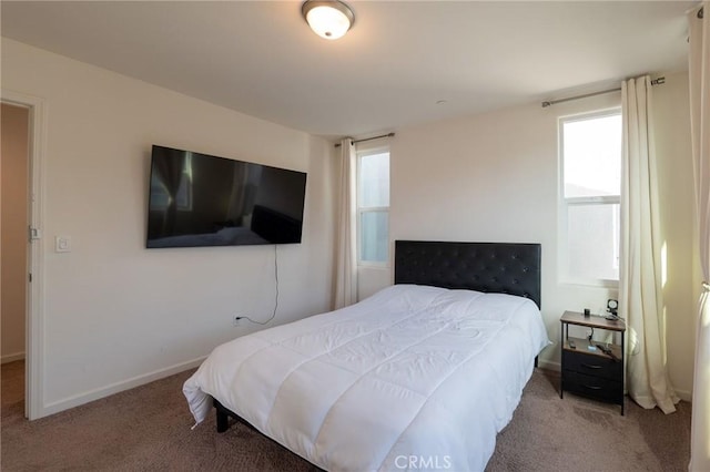 carpeted bedroom featuring baseboards