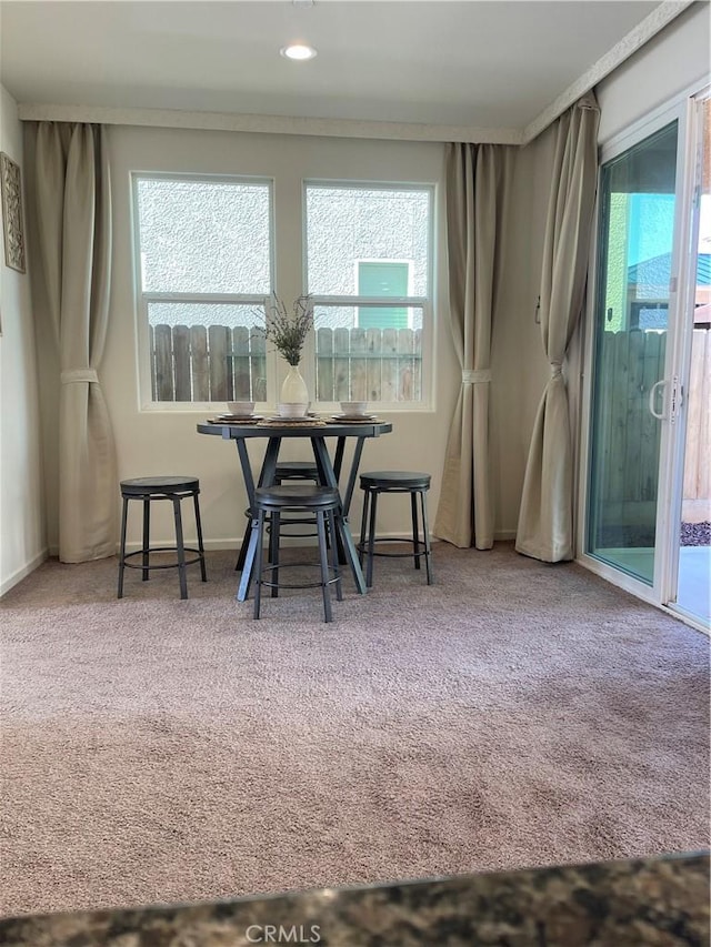 dining room with carpet, a healthy amount of sunlight, and recessed lighting