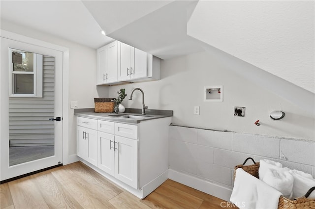 laundry area with light wood-type flooring, electric dryer hookup, washer hookup, and a sink