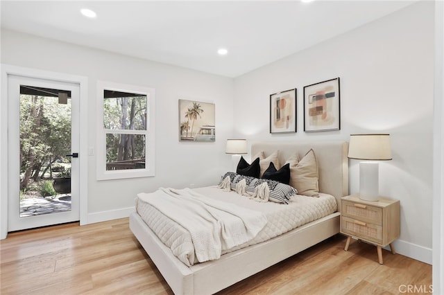 bedroom with access to outside, recessed lighting, light wood-style flooring, and baseboards