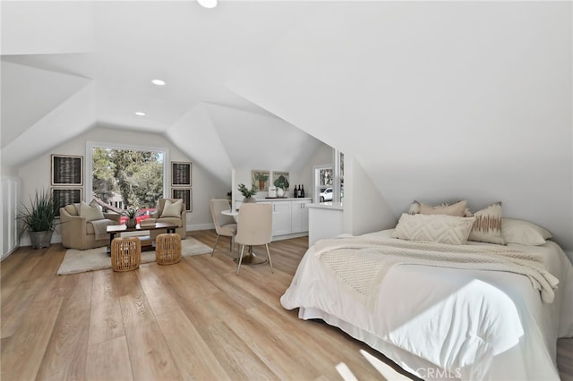 bedroom with light wood-type flooring, recessed lighting, and lofted ceiling