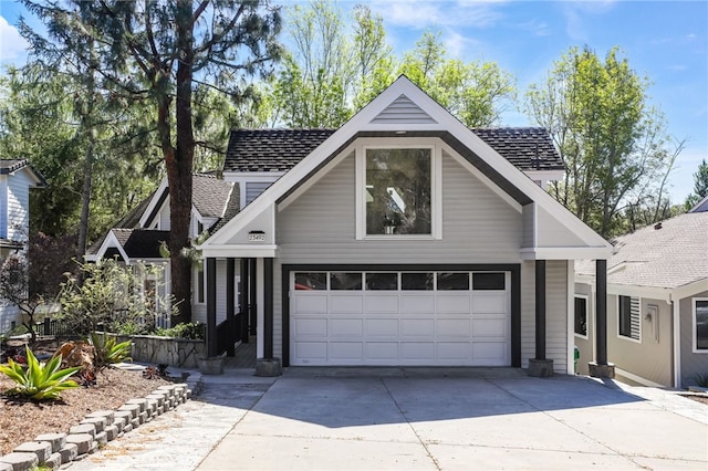 view of front of property featuring a shingled roof and a garage