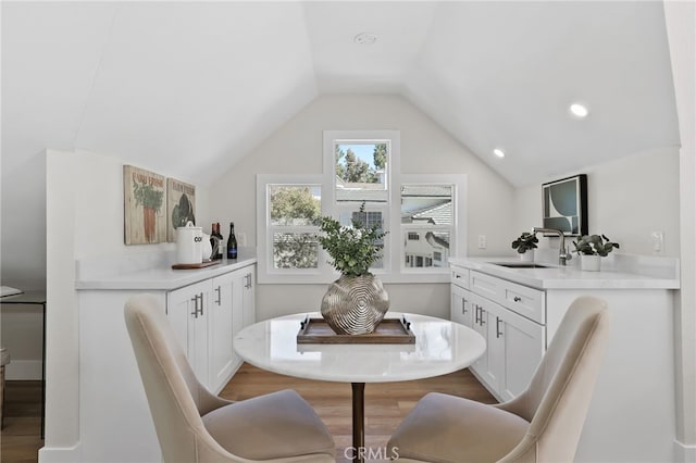 dining room featuring lofted ceiling, wood finished floors, and recessed lighting