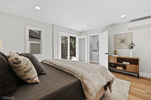 bedroom featuring access to outside, recessed lighting, light wood finished floors, and a wall mounted AC