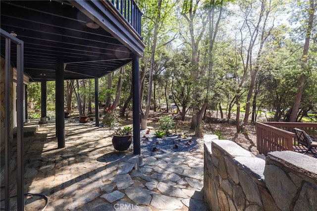 wooden terrace featuring a patio area