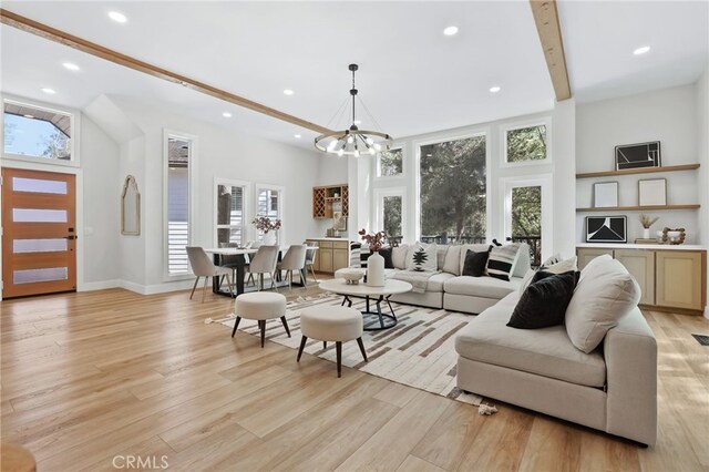 living area featuring baseboards, recessed lighting, light wood-style flooring, and an inviting chandelier