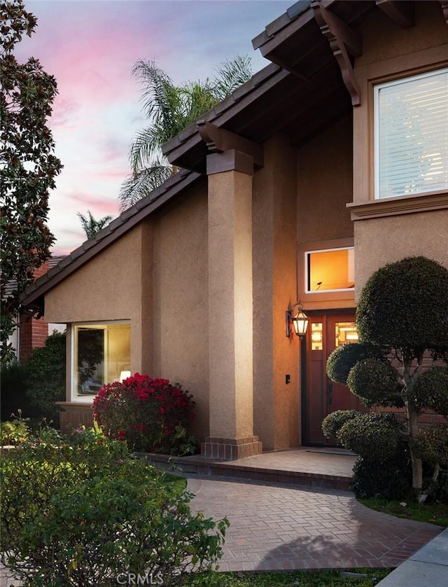 entrance to property with stucco siding