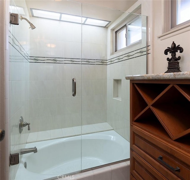 full bathroom with bath / shower combo with glass door