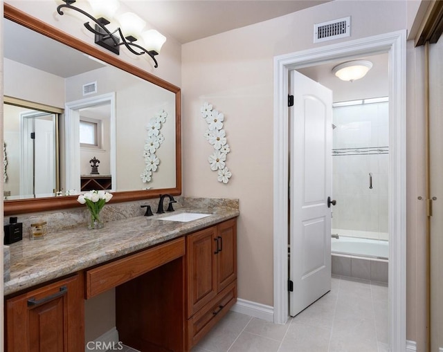 full bath with visible vents, tiled shower / bath combo, vanity, and tile patterned floors