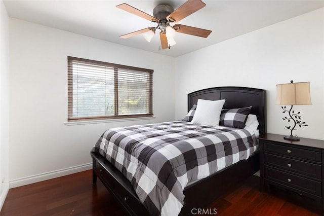 bedroom with ceiling fan, wood finished floors, and baseboards