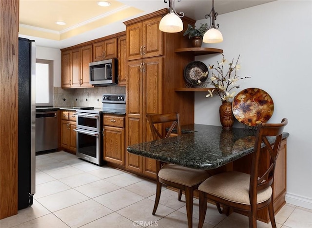 kitchen featuring open shelves, brown cabinetry, stainless steel appliances, and a raised ceiling