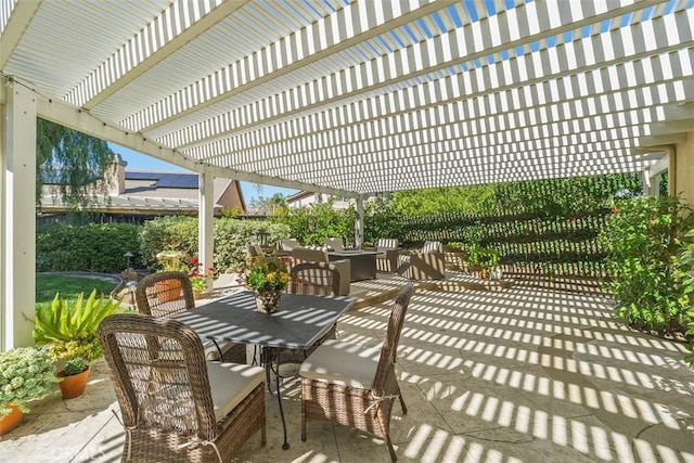 view of patio / terrace with outdoor dining area, fence, and a pergola