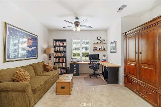 home office featuring baseboards, visible vents, ceiling fan, and light colored carpet