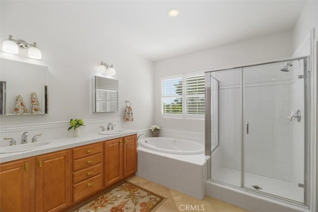 full bathroom featuring a bath, a sink, a shower stall, and tile patterned floors