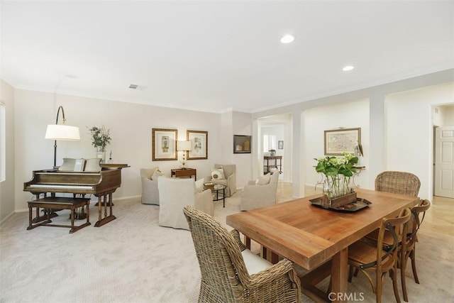 dining area with crown molding, recessed lighting, visible vents, and light colored carpet