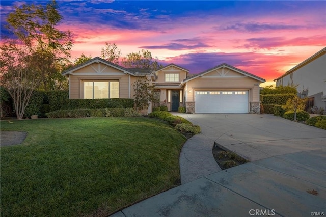 ranch-style house with stone siding, concrete driveway, a yard, and an attached garage