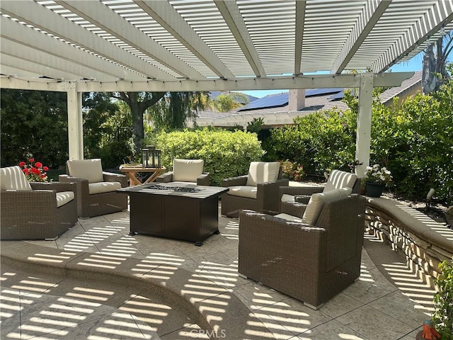 view of patio / terrace with an outdoor living space with a fire pit and a pergola