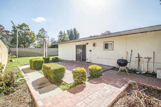 back of house featuring a patio area, fence, and stucco siding