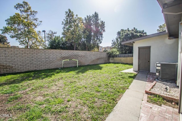 view of yard featuring central air condition unit and a fenced backyard