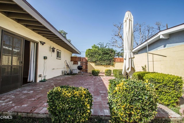 view of patio featuring fence