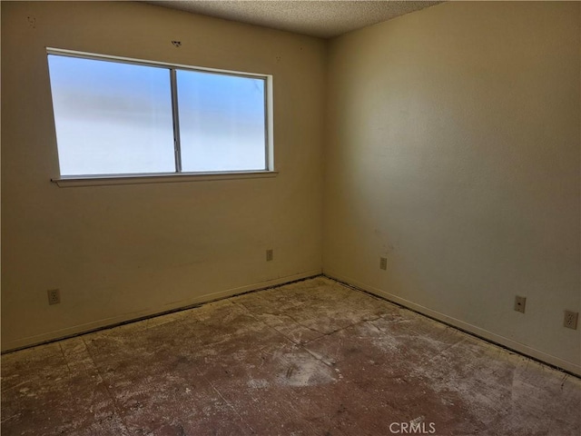 spare room with a textured ceiling