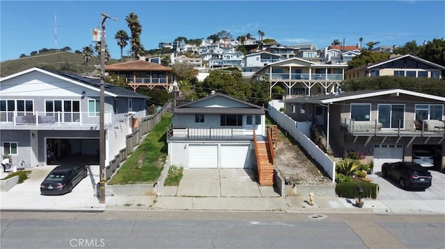 exterior space featuring a garage, a residential view, and concrete driveway