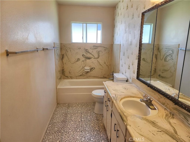 full bathroom with a bathtub, toilet, vanity, tile patterned flooring, and baseboards