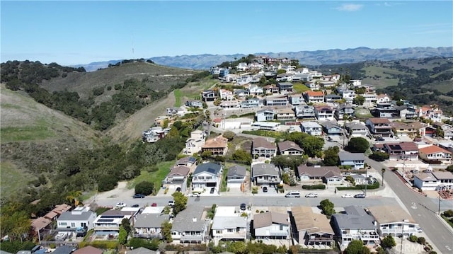 drone / aerial view featuring a residential view and a mountain view