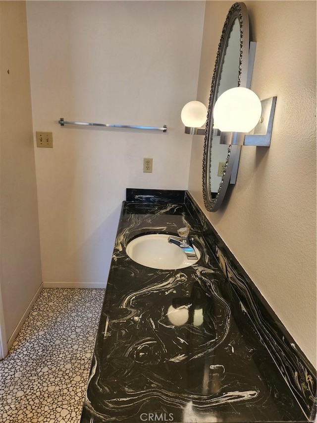 bathroom with baseboards and vanity