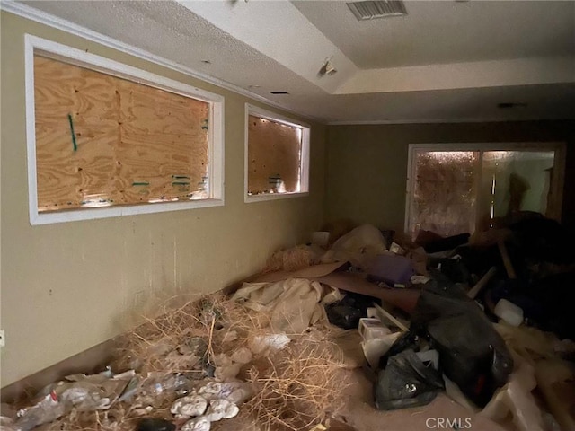 miscellaneous room featuring a tray ceiling, visible vents, and crown molding