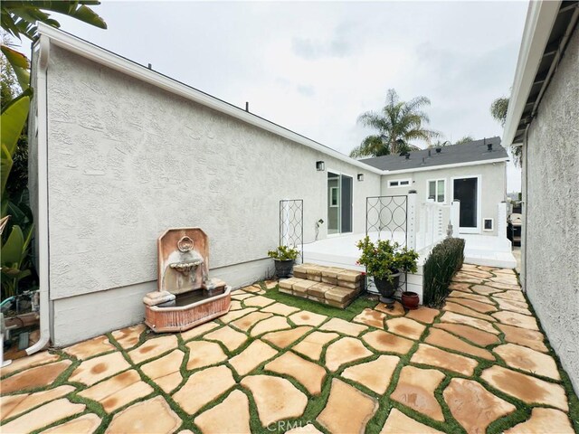 back of house featuring a patio area and stucco siding