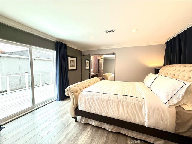 bedroom featuring a barn door, visible vents, access to exterior, crown molding, and light wood-style floors