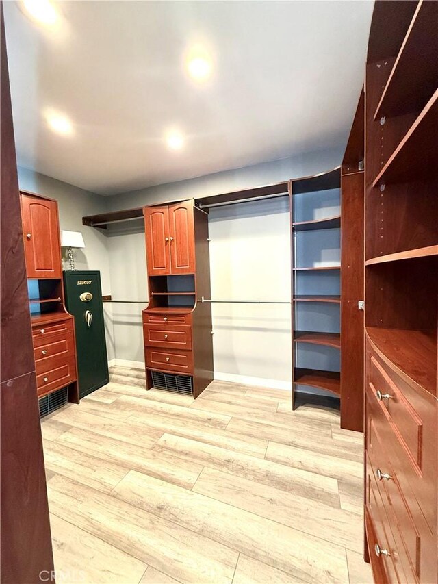 walk in closet featuring light wood-style flooring