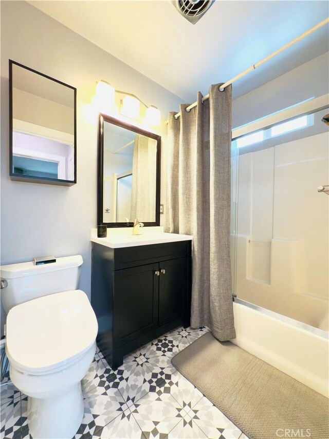 bathroom featuring visible vents, toilet, tile patterned floors, shower / bath combination with curtain, and vanity