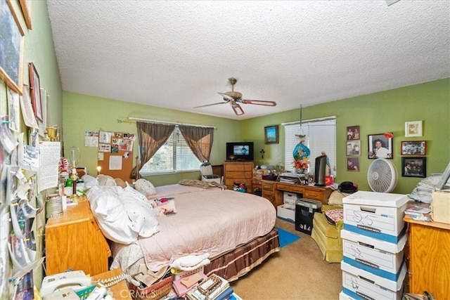 bedroom with carpet, ceiling fan, and a textured ceiling