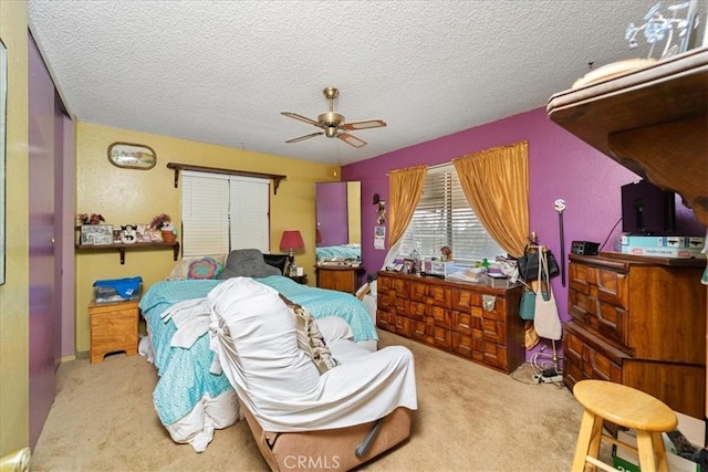 bedroom featuring a closet, carpet flooring, ceiling fan, and a textured ceiling