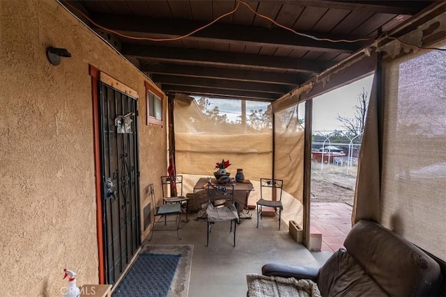 sunroom with wood ceiling and beam ceiling