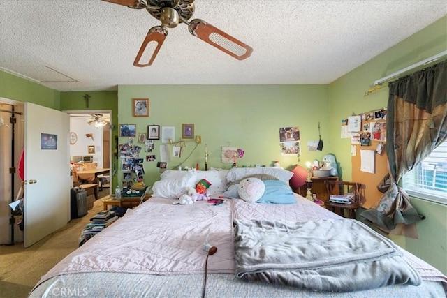 bedroom featuring carpet floors, ceiling fan, and a textured ceiling