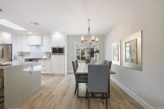 dining room with recessed lighting, visible vents, baseboards, light wood finished floors, and an inviting chandelier