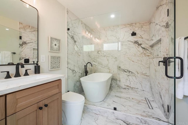 full bathroom featuring marble finish floor, a freestanding bath, vanity, and a marble finish shower