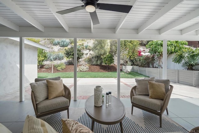 sunroom with beam ceiling and ceiling fan