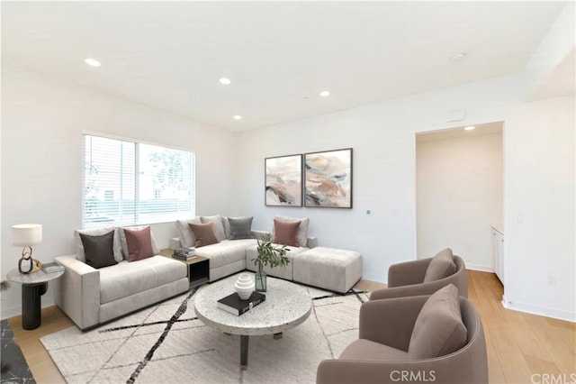 living room with baseboards, light wood-type flooring, and recessed lighting