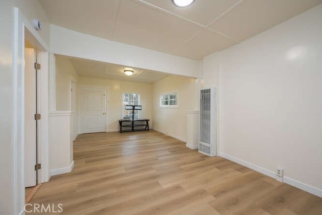 unfurnished room featuring light wood-style flooring and baseboards