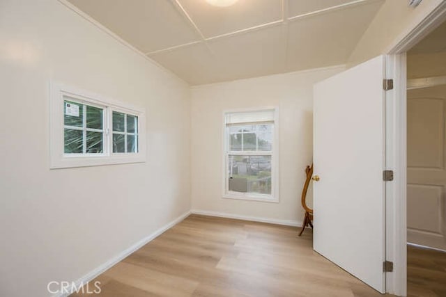 empty room featuring light wood-type flooring and baseboards